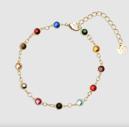 An upclose image of the bejeweled bracelet with various stones representing the different eras